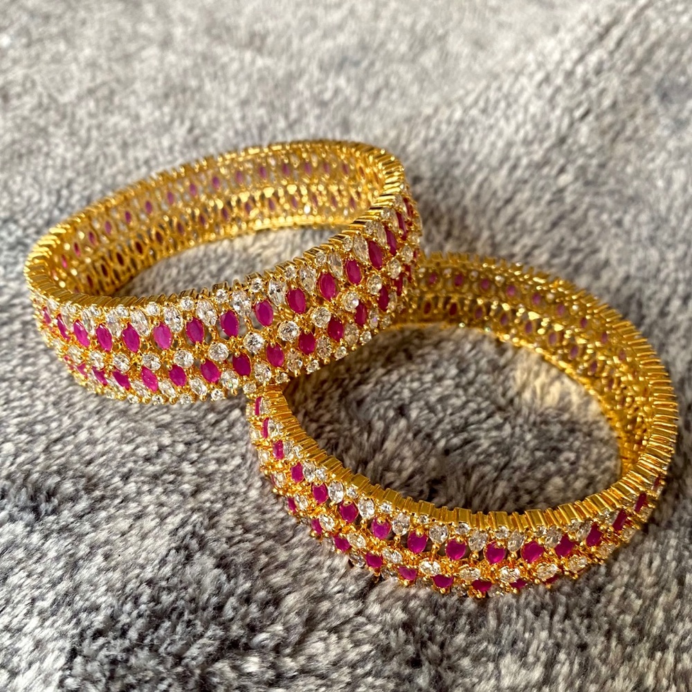 2 gold, silver and pink stone bangles